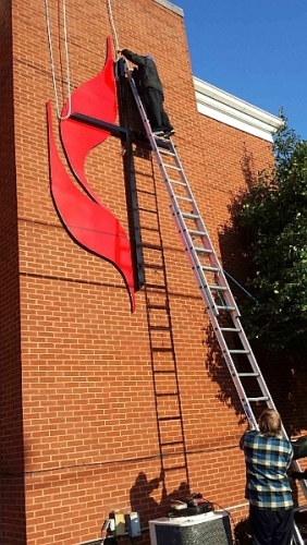 Installing a United Methodist cross and flames sign