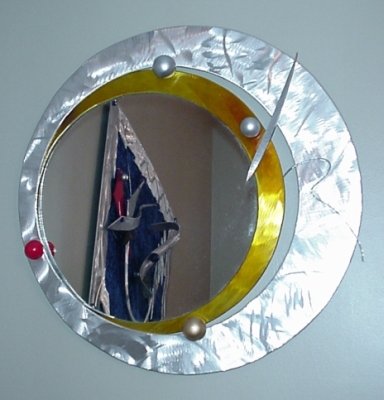 modern wall mirror, circle shaped mirror, Mirror in brushed aluminum and contemporary style mirror. Mirror is abstarct mirror with a modern mirror flare.