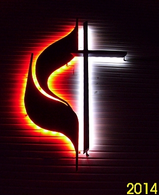LED backlit UMC cross and flames and United methodist cross and flame sign night pic